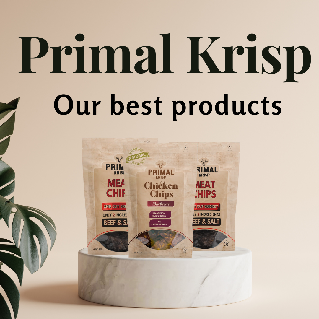 Primal Krisp Beef Krisps in kraft packaging, with thin-cut beef chips on a slate surface — clean protein snack made from brisket and sea salt