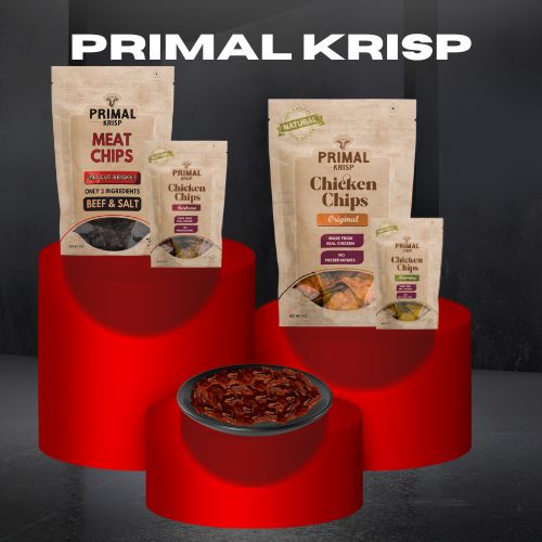 Primal Krisp Beef Krisps in kraft packaging, with thin-cut beef chips on a slate surface — clean protein snack made from brisket and sea salt