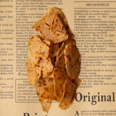 Primal Krisp protein crisps stacked on parchment paper